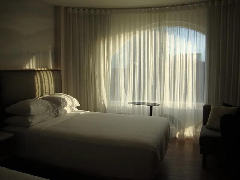 Freshly made hotel-quality bed linens in a vacation rental bedroom ready for guest check-in